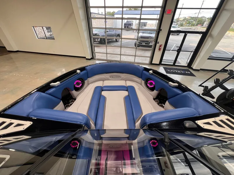 Slide: The Image of Interior view of a 2021 Supra SL 400 boat with blue and gray seating. - 20