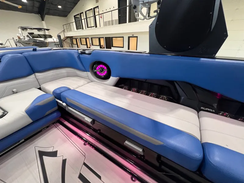 Slide: The Image of Interior of a 2021 Supra SL 400 with blue and white seating. - 22