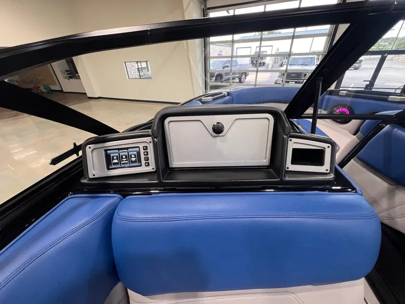 Slide: The Image of Interior of 2021 Supra SL 400 with blue seats and control console. - 24