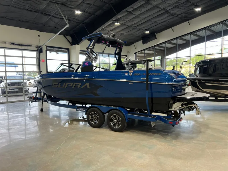Slide: The Image of 2021 Supra SL 400 boat displayed in showroom. - 3