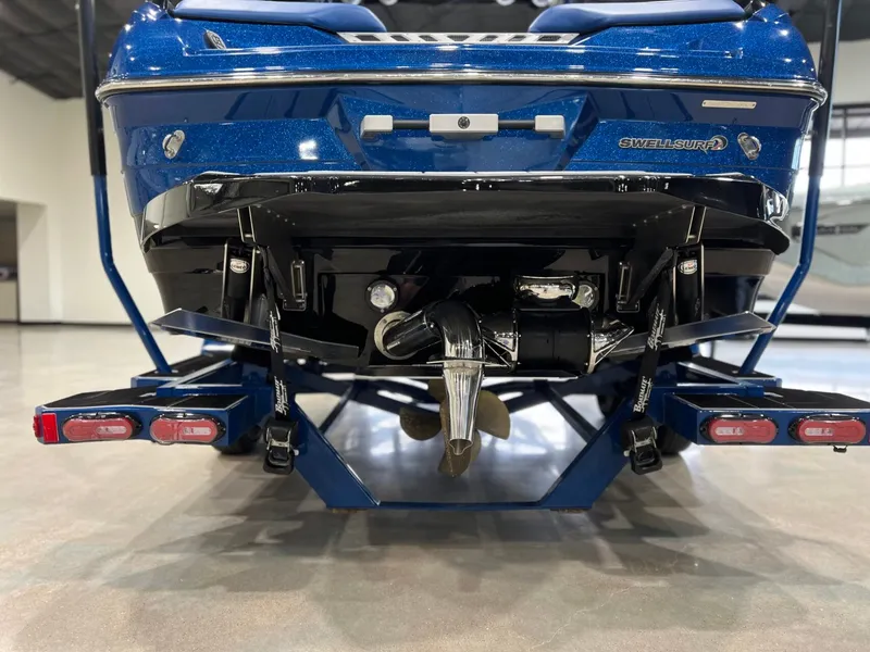 Slide: The Image of Rear view of a blue 2021 Supra SL 400 boat on a trailer. - 5
