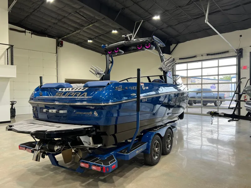 Slide: The Image of 2021 Supra SL 400 boat in a modern garage. - 8