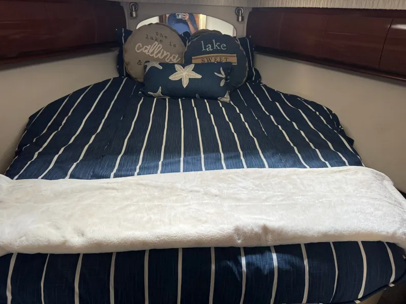 Slide: The Image of Interior of 2008 Sea Ray 44 Sundancer with striped bedding. - 20