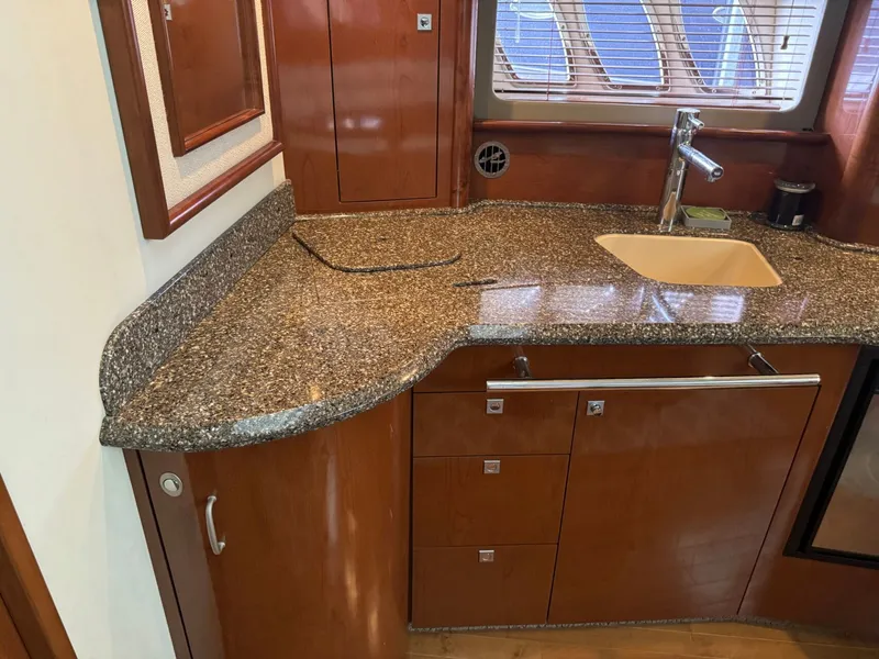 Slide: The Image of Sea Ray 44 Sundancer 2008 kitchen area with granite countertop. - 27