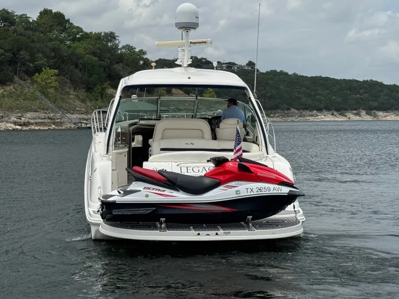 Slide: The Image of 2008 Sea Ray 44 Sundancer with jet ski on water. - 3