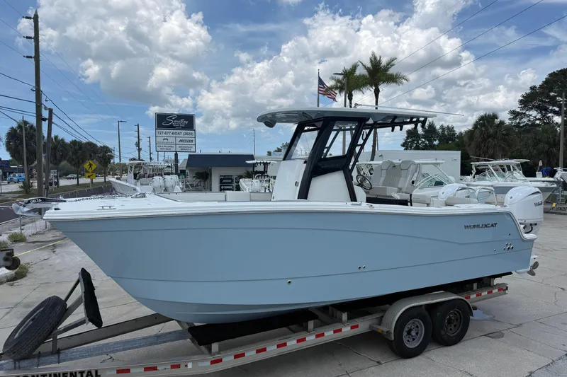 The Image of 2026 World Cat 265 CC-X boat on trailer, displayed outdoors under a partly cloudy sky. - 1