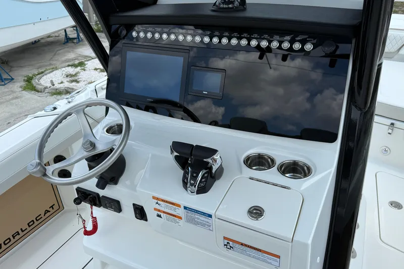 Slide: The Image of 2026 World Cat 265 CC-X boat dashboard with steering wheel and control panel. - 12