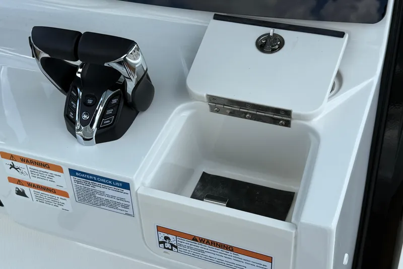 Slide: The Image of Control panel of 2026 World Cat 265 CC-X boat with throttle and storage compartment. - 13