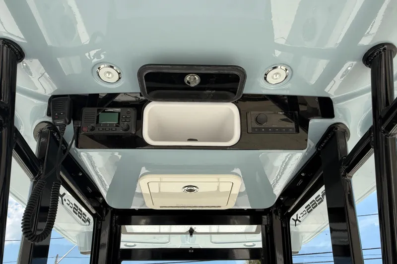 Slide: The Image of 2026 World Cat 265 CC-X boat interior with electronics and storage compartment. - 14