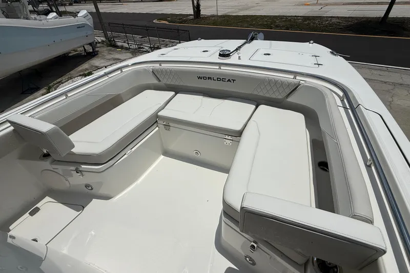 Slide: The Image of 2026 World Cat 265 CC-X boat interior with white cushioned seating and storage compartments. - 17