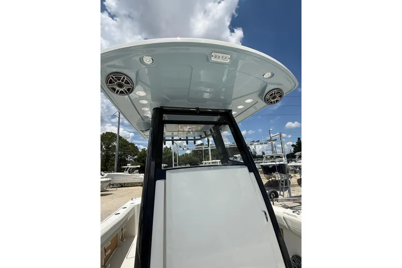 Slide: The Image of 2026 World Cat 265 CC-X boat console with speakers and lighting under a clear sky. - 21