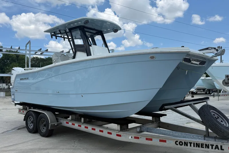 Slide: The Image of 2026 World Cat 265 CC-X boat on trailer under blue sky. - 5