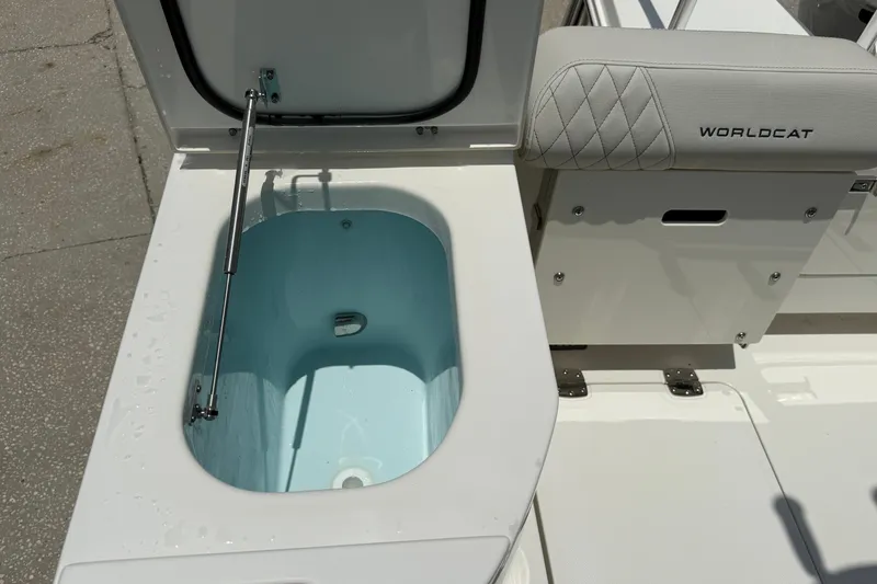 Slide: The Image of Livewell compartment on 2026 World Cat 265 CC-X boat, featuring cushioned seating and hydraulic support. - 8