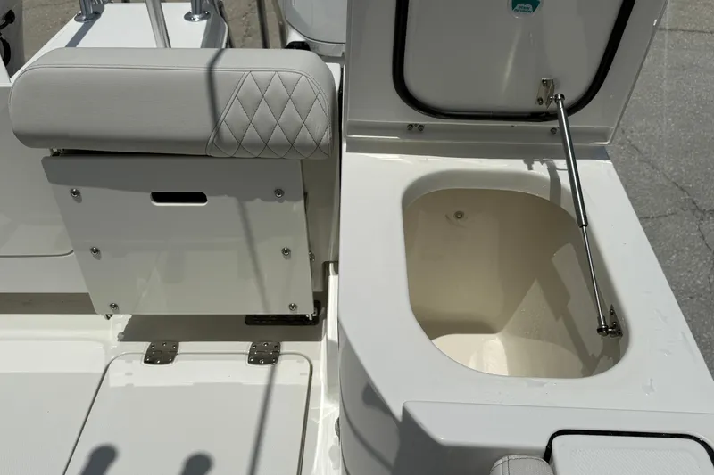 Slide: The Image of 2026 World Cat 265 CC-X boat interior with open storage compartment and cushioned seating. - 9