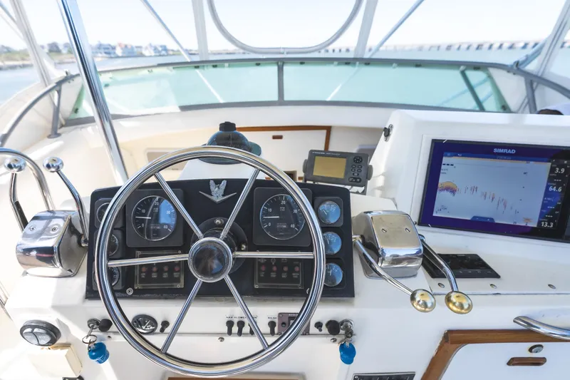 Slide: The Image of Helm of 1986 Bertram 35 Flybridge Sportfish with steering wheel and navigation equipment. - 10