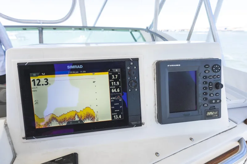 Slide: The Image of Control panel of a 1986 Bertram 35 Flybridge Sportfish with Simrad and Furuno displays. - 11