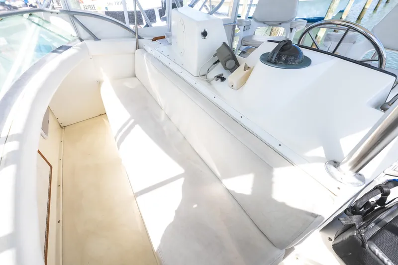 Slide: The Image of 1986 Bertram 35 Flybridge Sportfish helm area with seating and navigation equipment. - 12