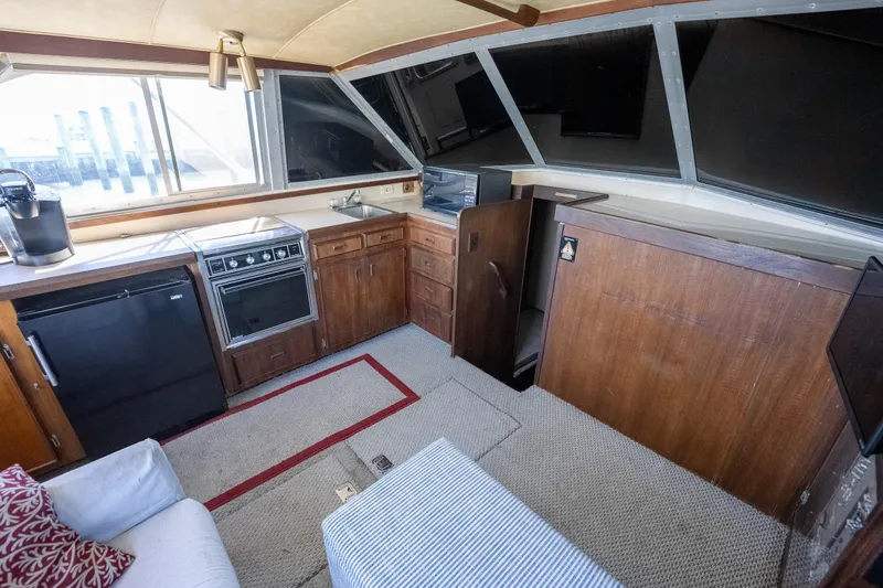 Slide: The Image of Interior of 1986 Bertram 35 Flybridge Sportfish with kitchen and seating area. - 16