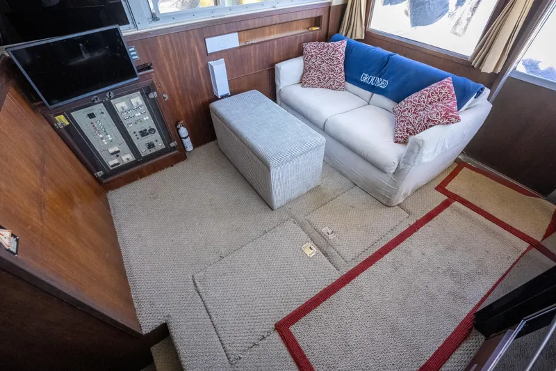 Slide: The Image of Interior of 1986 Bertram 35 Flybridge Sportfish with sofa, control panel, and carpeted floor. - 18