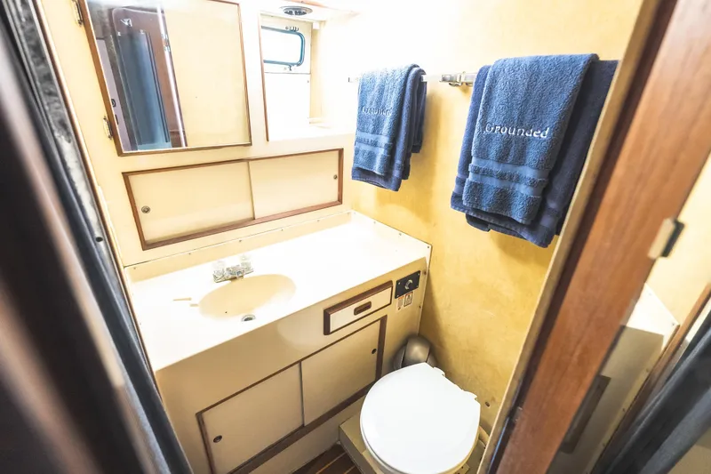 Slide: The Image of Compact bathroom in 1986 Bertram 35 Flybridge Sportfish with towels and mirror. - 19