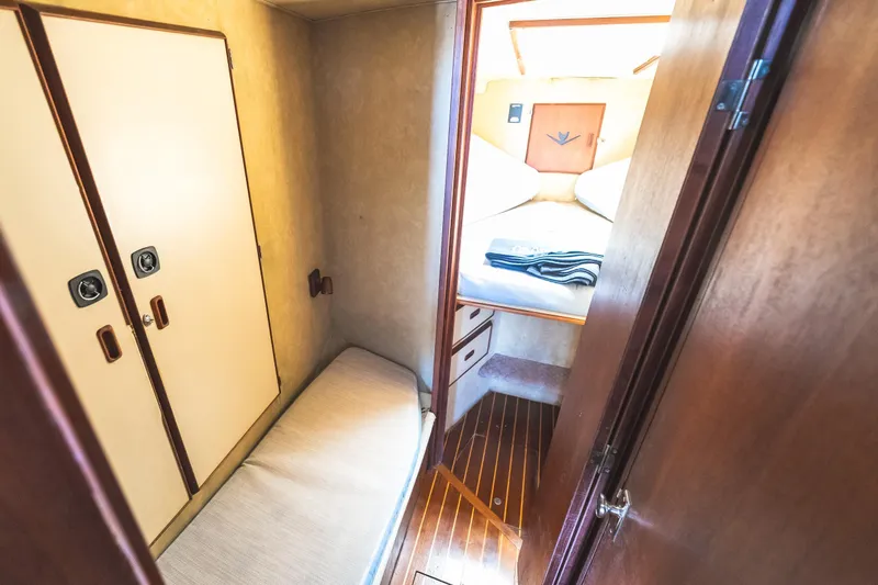 Slide: The Image of Interior cabin of 1986 Bertram 35 Flybridge Sportfish with cozy bed and wooden accents. - 20