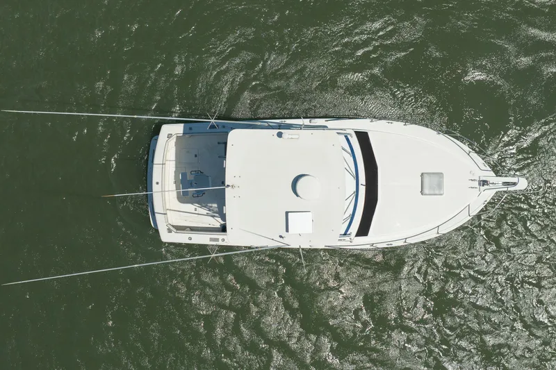 Slide: The Image of Aerial view of 1986 Bertram 35 Flybridge Sportfish boat on water. - 6