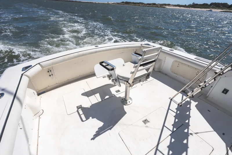 Slide: The Image of 1986 Bertram 35 Flybridge Sportfish boat deck with fishing chair on open water. - 7
