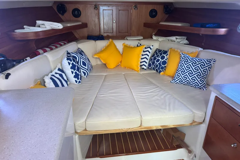 Slide: The Image of Cozy interior of 2006 MJM 34z Downeast with colorful cushions and wooden accents. - 12
