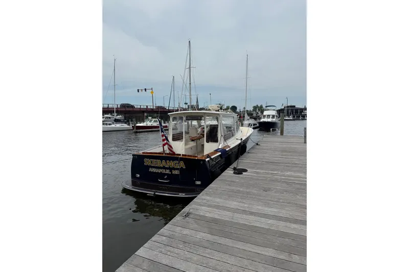 Slide: The Image of 2006 MJM 34z Downeast boat docked in Annapolis marina, displaying American flag. - 2