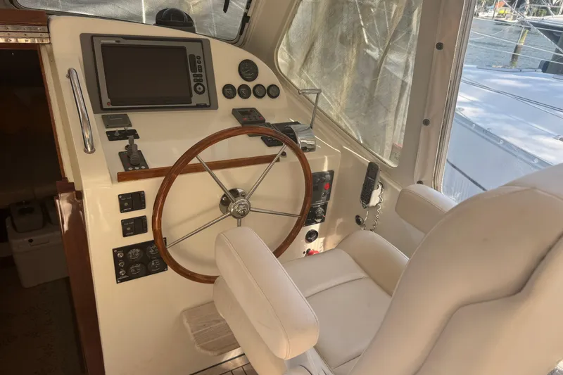 Slide: The Image of Helm of 2006 MJM 34z Downeast boat with steering wheel and navigation controls. - 9