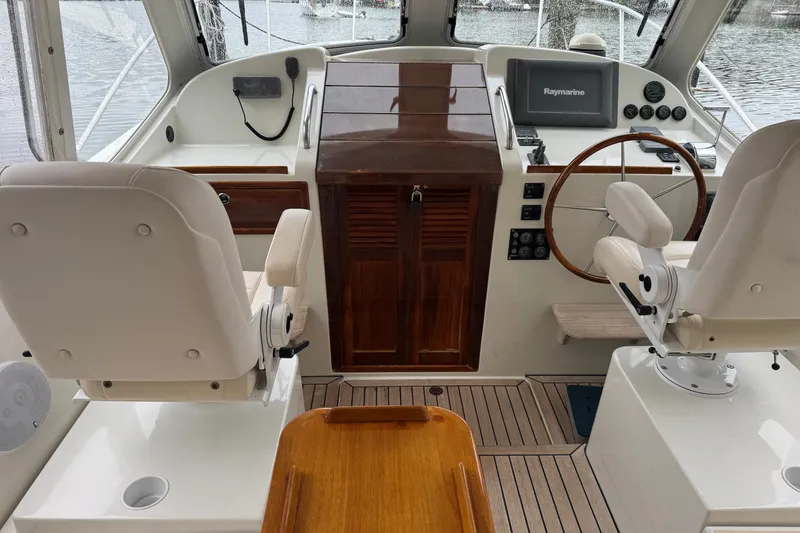 Slide: The Image of Interior view of 2006 MJM 34z Downeast boat cockpit with steering wheel and controls. - 1