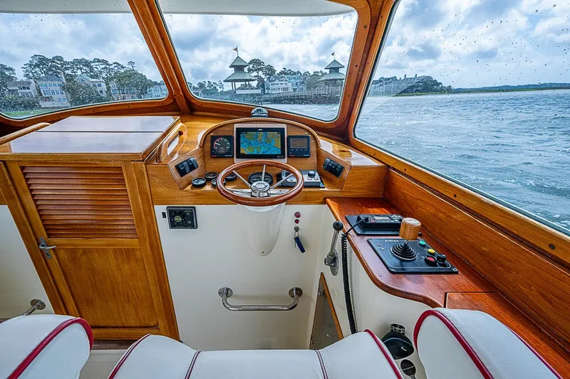 Slide: The Image of Interior helm of 1996 Hinckley Picnic Boat 36 Classic with wooden dashboard and navigation equipment. - 10
