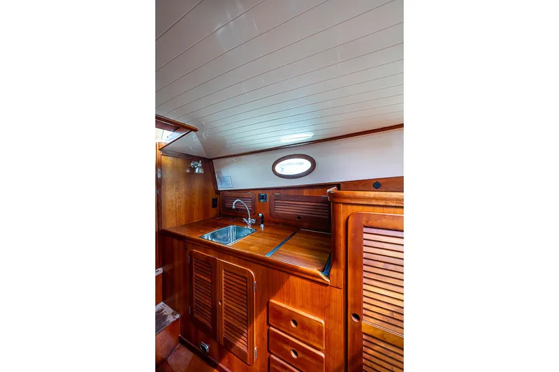 Slide: The Image of Interior of 1996 Hinckley Picnic Boat 36 Classic with wooden cabinetry and sink. - 11