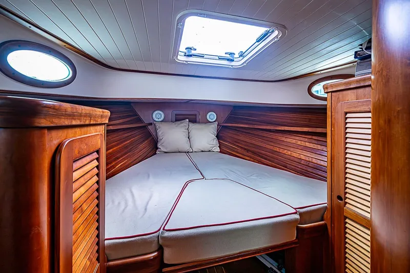 Slide: The Image of Cozy cabin interior of 1996 Hinckley Picnic Boat 36 Classic with wooden finish and bedding. - 14