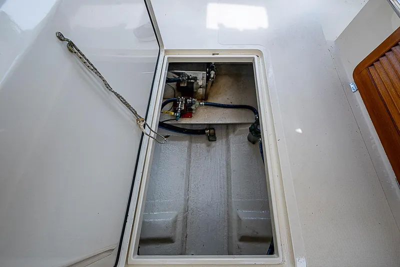 Slide: The Image of Open engine compartment of 1996 Hinckley Picnic Boat 36 Classic, showcasing mechanical components. - 19