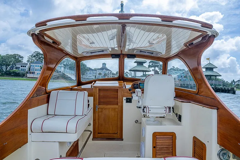 Slide: The Image of 1996 Hinckley Picnic Boat 36 Classic interior with wooden accents and white seating. - 9