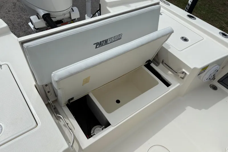 Slide: The Image of 2025 Pathfinder 2200 TRS boat with open storage compartment and visible engine. - 10