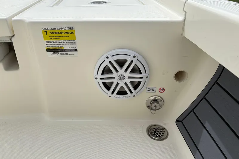 Slide: The Image of 2025 Pathfinder 2200 TRS boat interior with speaker, capacity label, and fresh water access. - 14