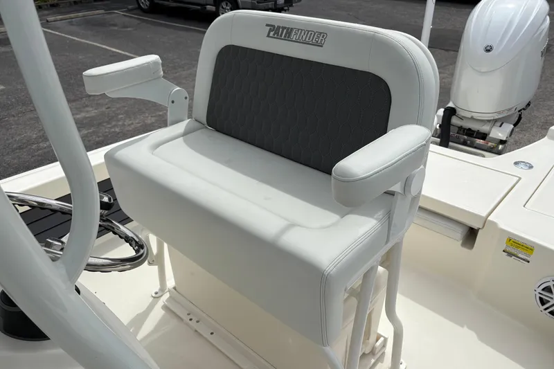 Slide: The Image of 2025 Pathfinder 2200 TRS boat seat with armrests and steering wheel, showcasing luxury design. - 19