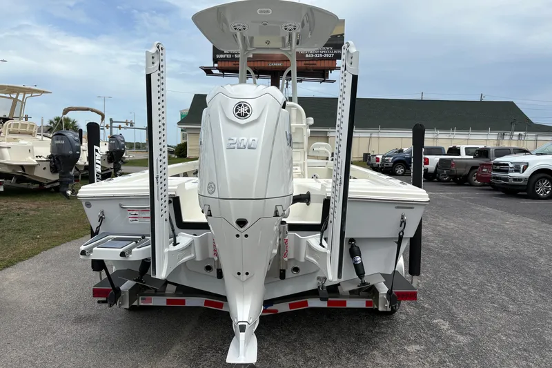 Slide: The Image of 2025 Pathfinder 2200 TRS boat with Yamaha 200 engine, parked on a trailer. - 2