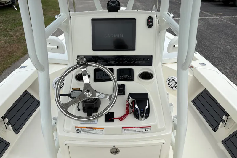 Slide: The Image of 2025 Pathfinder 2200 TRS boat console with steering wheel and Garmin display. - 20