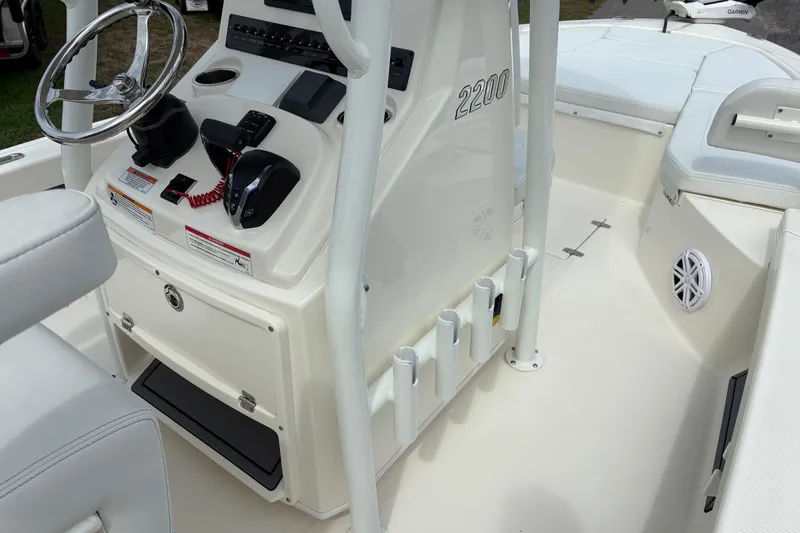 Slide: The Image of 2025 Pathfinder 2200 TRS boat interior with steering console and seating area. - 25
