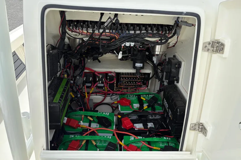 Slide: The Image of Electrical compartment of 2025 Pathfinder 2200 TRS boat, showcasing wiring and batteries. - 29