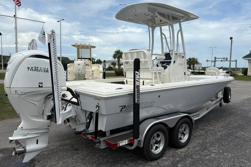 Slide: The Image of 2025 Pathfinder 2200 TRS boat with Yamaha engine on a trailer, parked outdoors. - 3