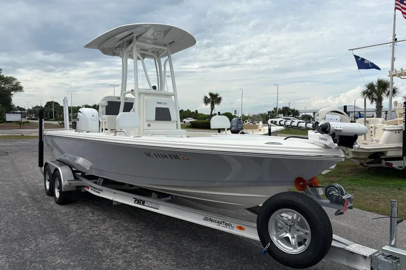 Slide: The Image of 2025 Pathfinder 2200 TRS boat on trailer, parked outdoors under cloudy sky. - 5
