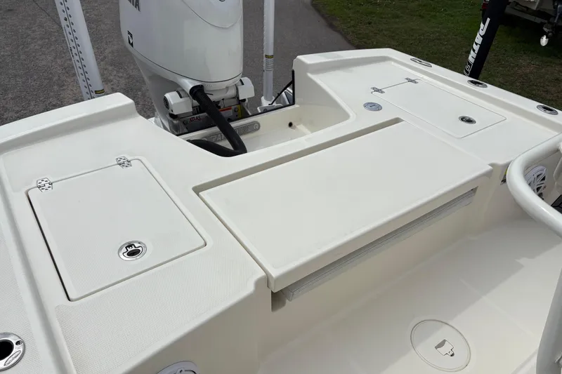 Slide: The Image of 2025 Pathfinder 2200 TRS boat deck with storage compartments and motor. - 8