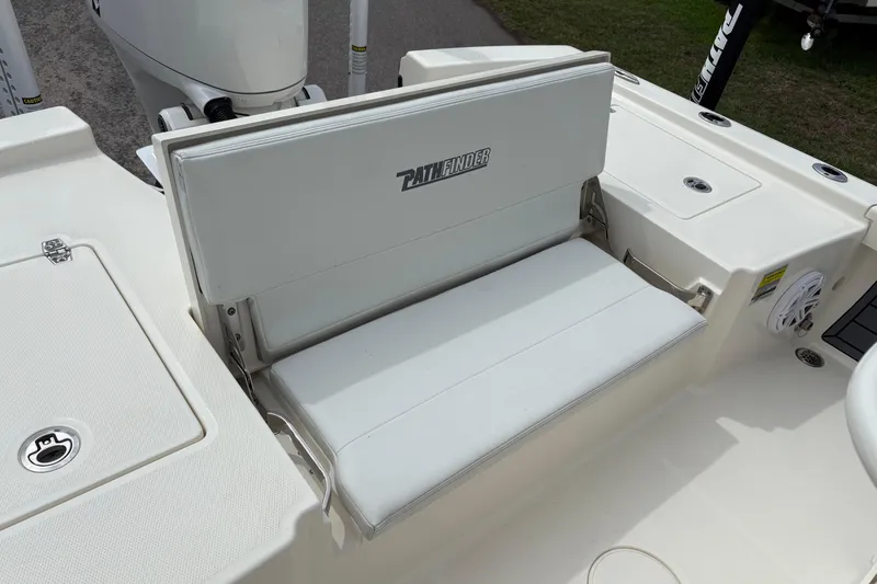 Slide: The Image of 2025 Pathfinder 2200 TRS boat seat with white upholstery and storage compartment. - 9