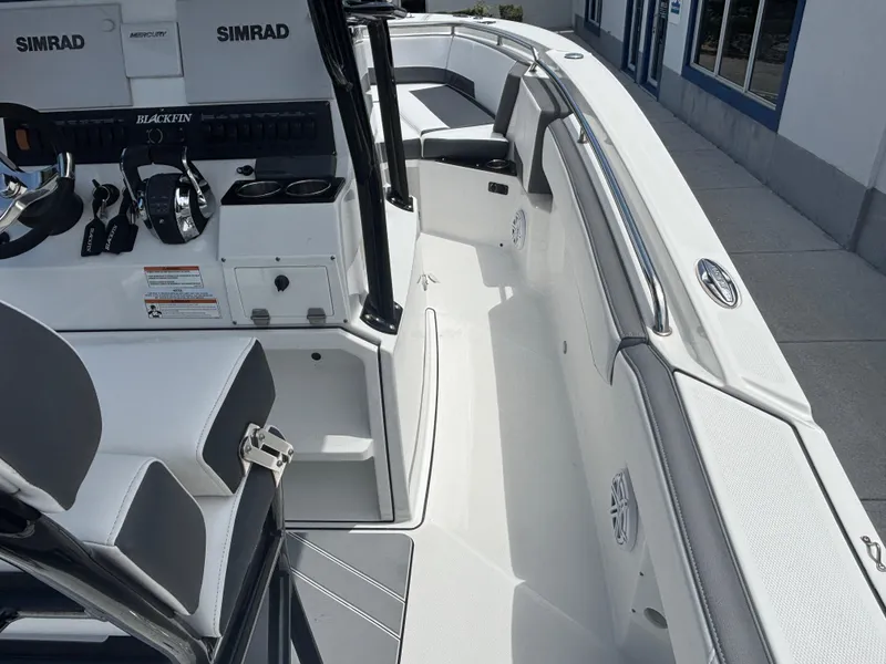 Slide: The Image of 2019 Blackfin 242 CC boat interior with Simrad electronics and sleek seating. - 16