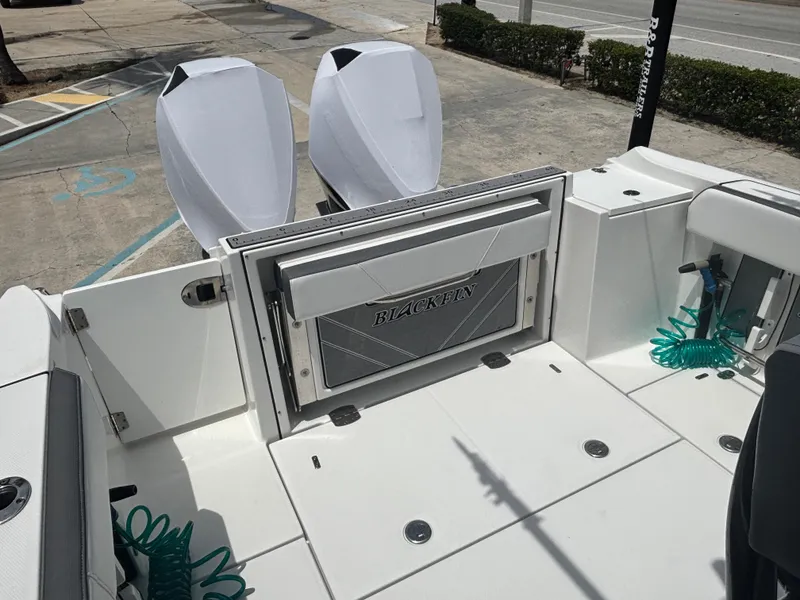 Slide: The Image of 2019 Blackfin 242 CC boat deck with dual engines and storage compartment. - 4