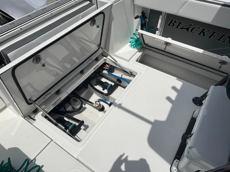 Slide: The Image of 2019 Blackfin 242 CC boat interior with open storage compartments and visible equipment. - 5